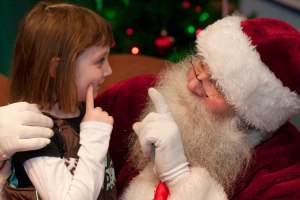 A young guests tells Santa her wish list during Brookfield Zoo’s Holiday Magic. Santa will be at the evening festival on Saturdays and Sundays beginning November 30 through December 22.